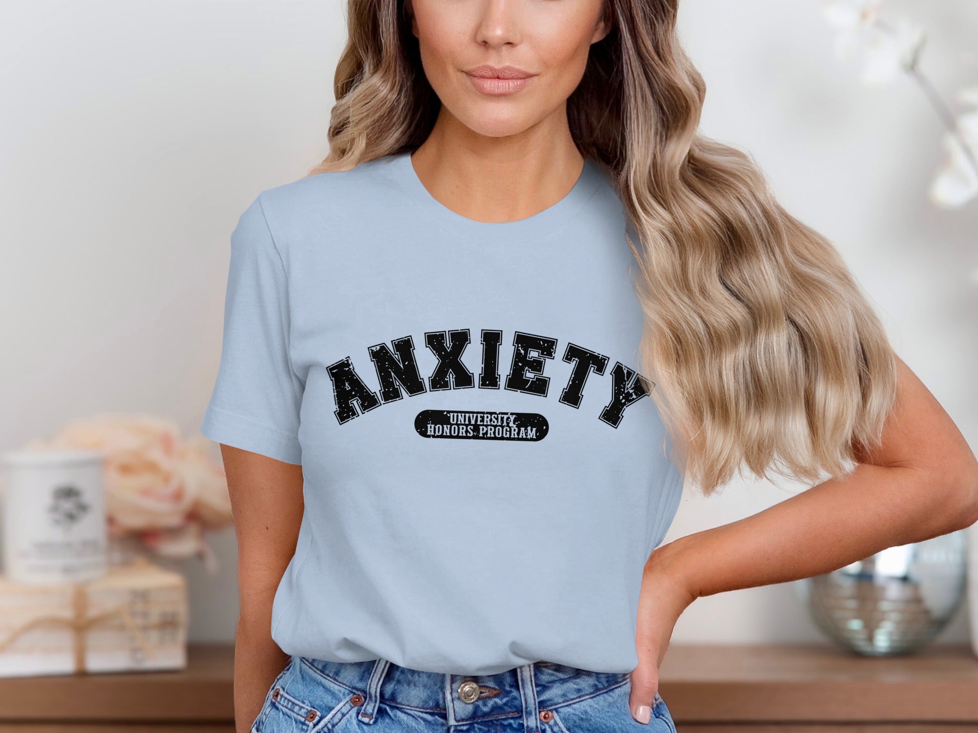 Light blue t-shirt with black distressed "ANXIETY UNIVERSITY HONORS PROGRAM" text.