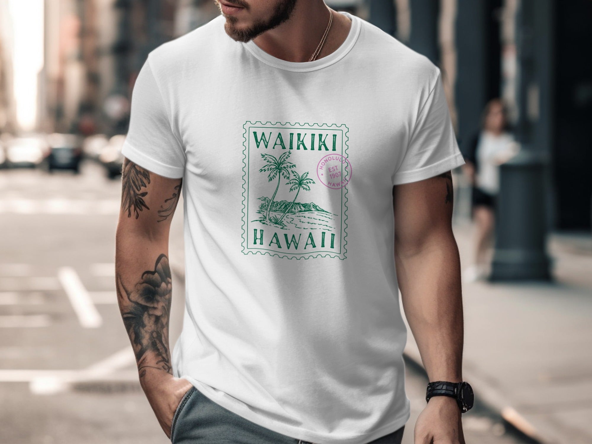 White t-shirt with green stamp graphic featuring "WAIKIKI HAWAII" and palm trees.