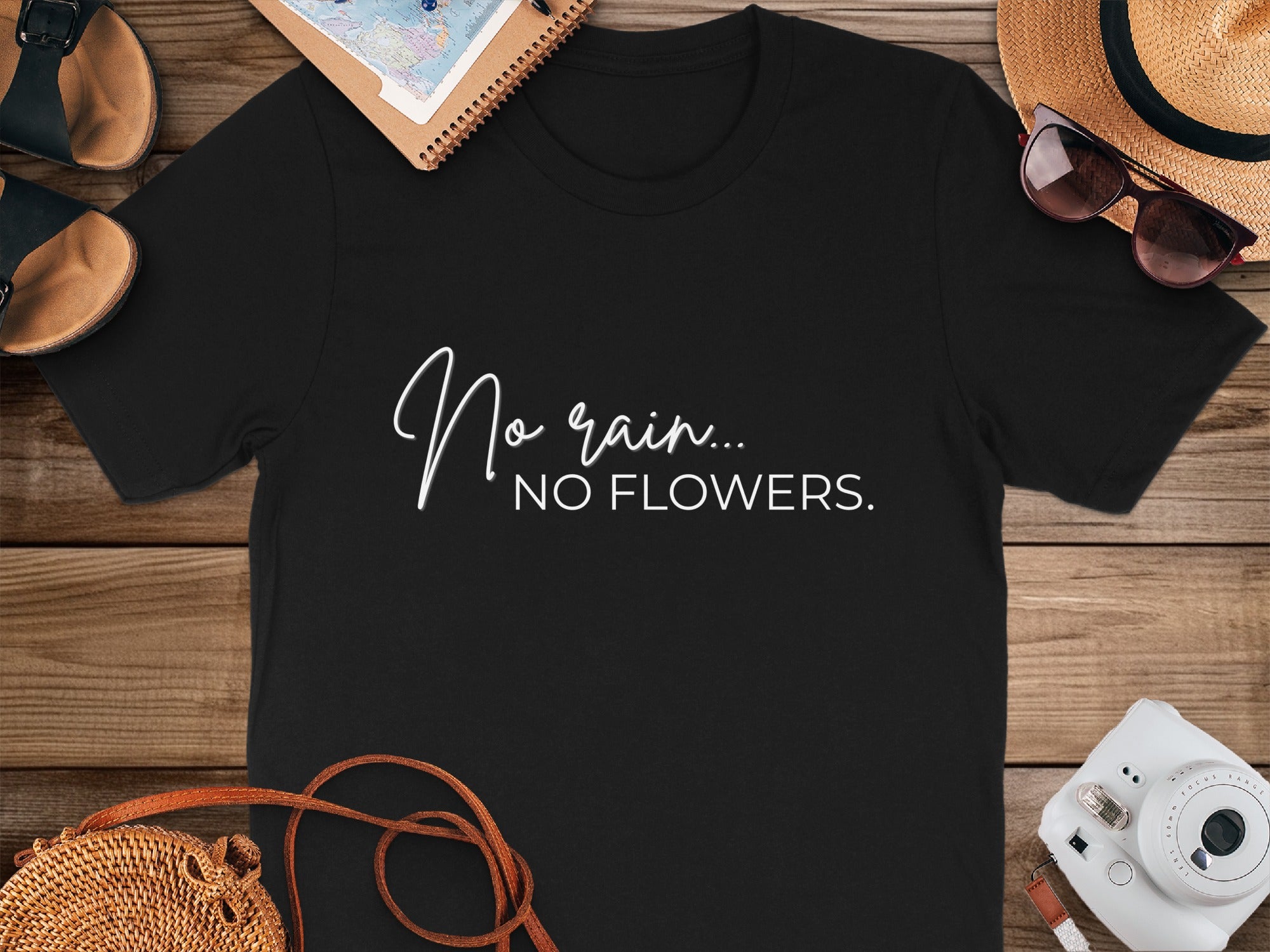 Black t-shirt with white text reading "No rain... NO FLOWERS."