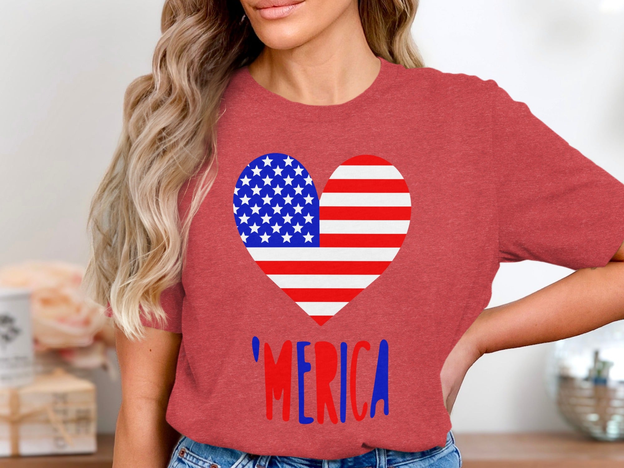 A woman wearing a red t-shirt with an American flag heart graphic and 'MERICA text.