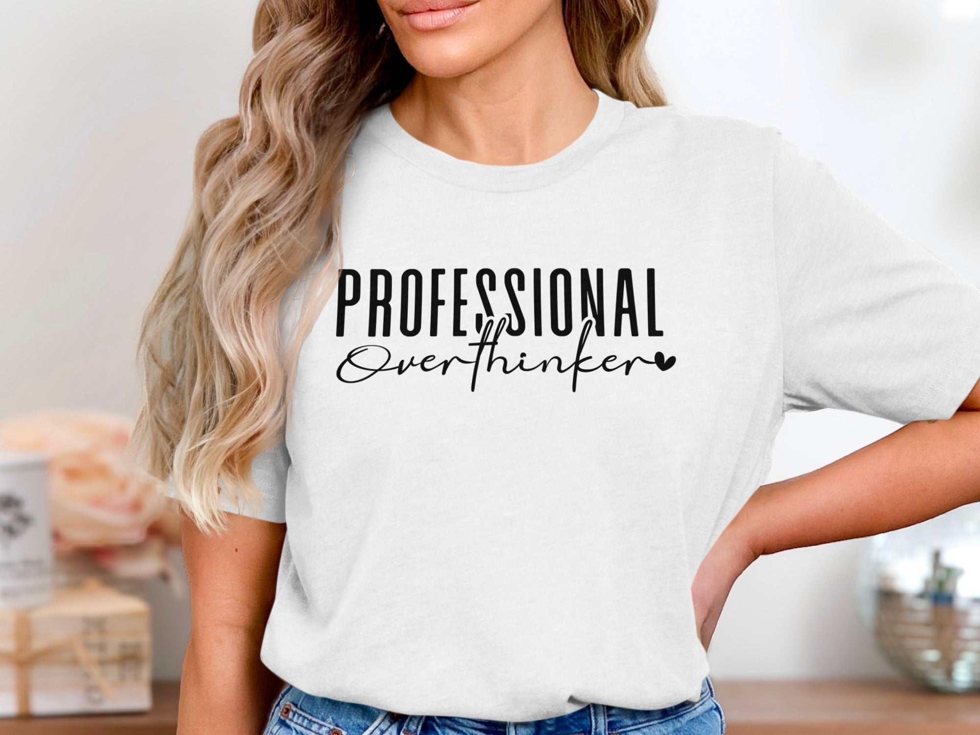 White t-shirt with black text "PROFESSIONAL Overthinker" and a heart.