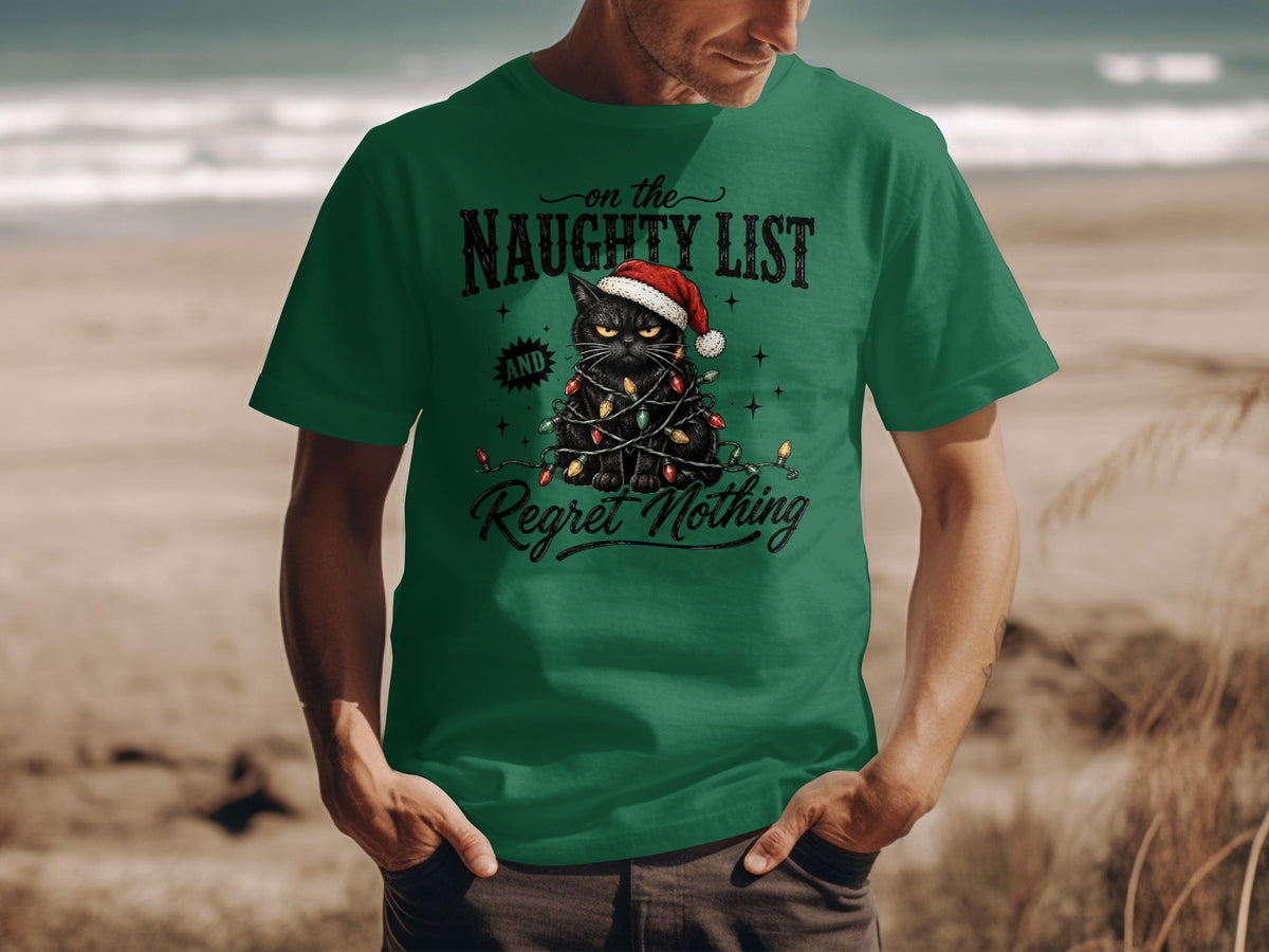 A man wearing a green t-shirt printed with a grumpy black cat tangled in Christmas lights.