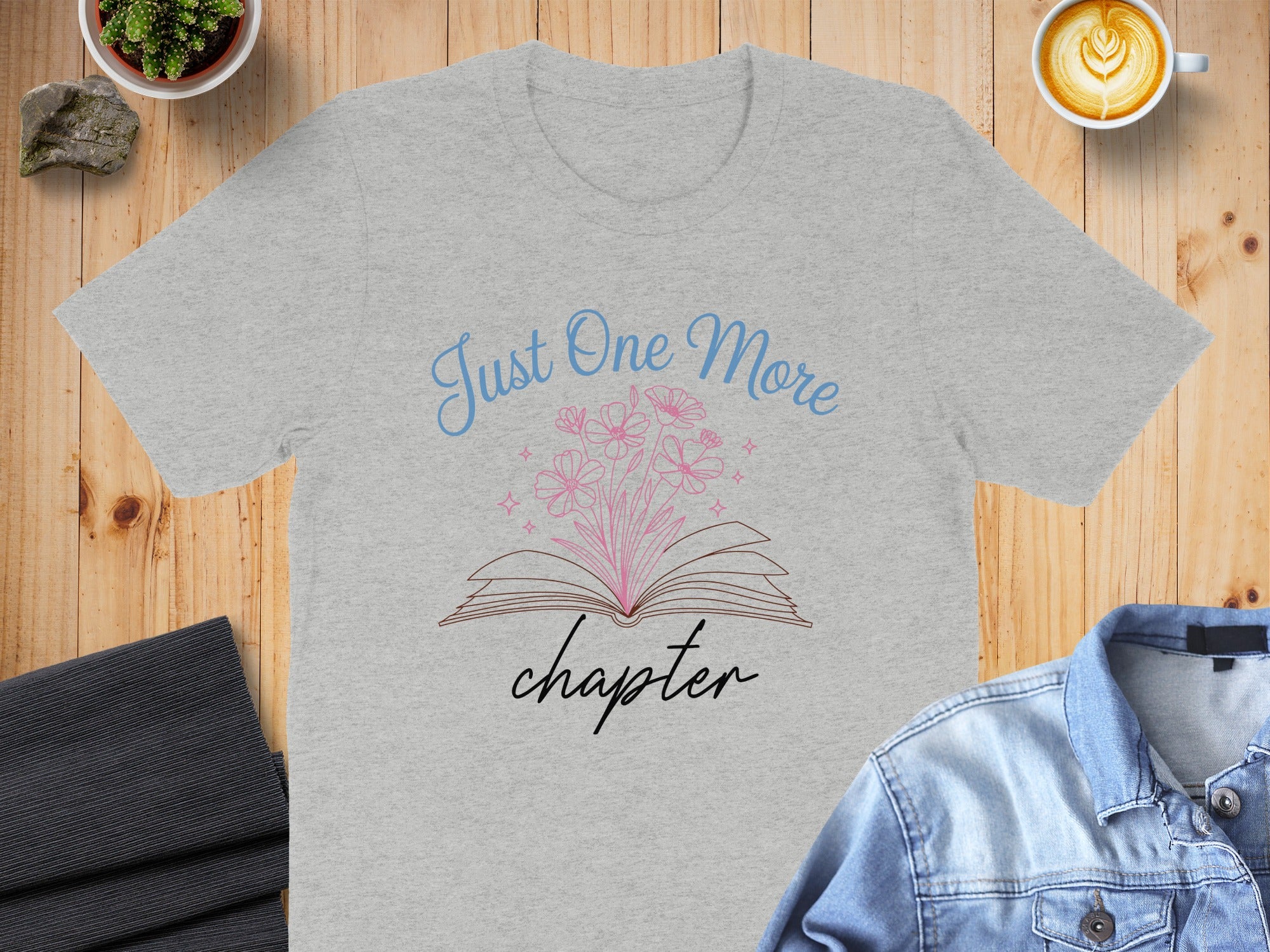 Grey t-shirt with "Just One More Chapter" book and flower graphic.