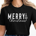 Black t-shirt with white text "Merry Christmas" and a line-art Christmas tree.