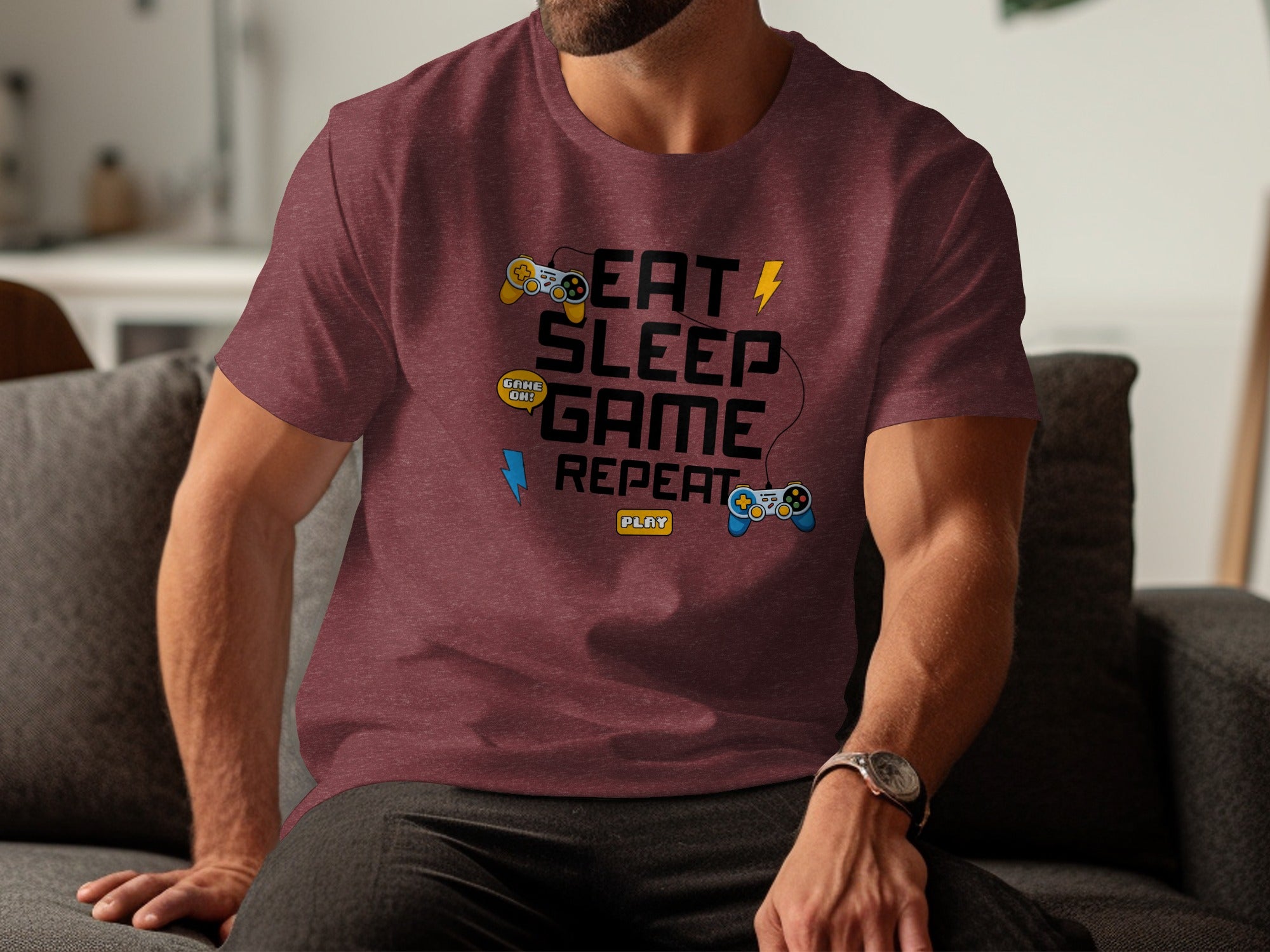 Maroon t-shirt with "Eat Sleep Game Repeat" and gaming controller graphics.