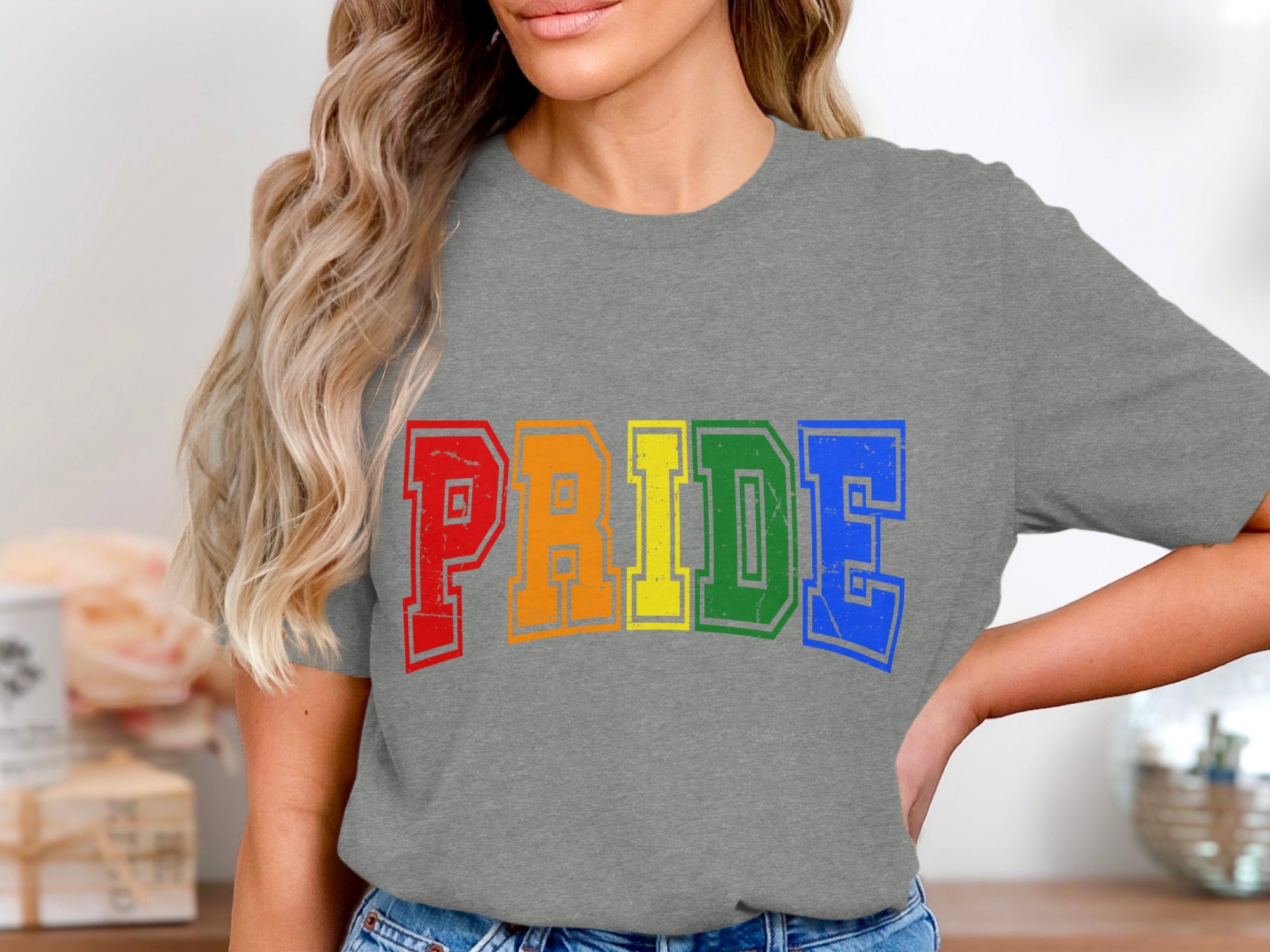 Grey t-shirt with rainbow "PRIDE" text in distressed block letters.