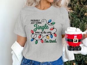 Light gray t-shirt with "Probably Just Gonna Jingle Some of the Way. I'm Tired." and Christmas lights.