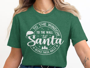 Green t-shirt with white text "To The Window To The Wall 'Til Santa Decks These Halls".