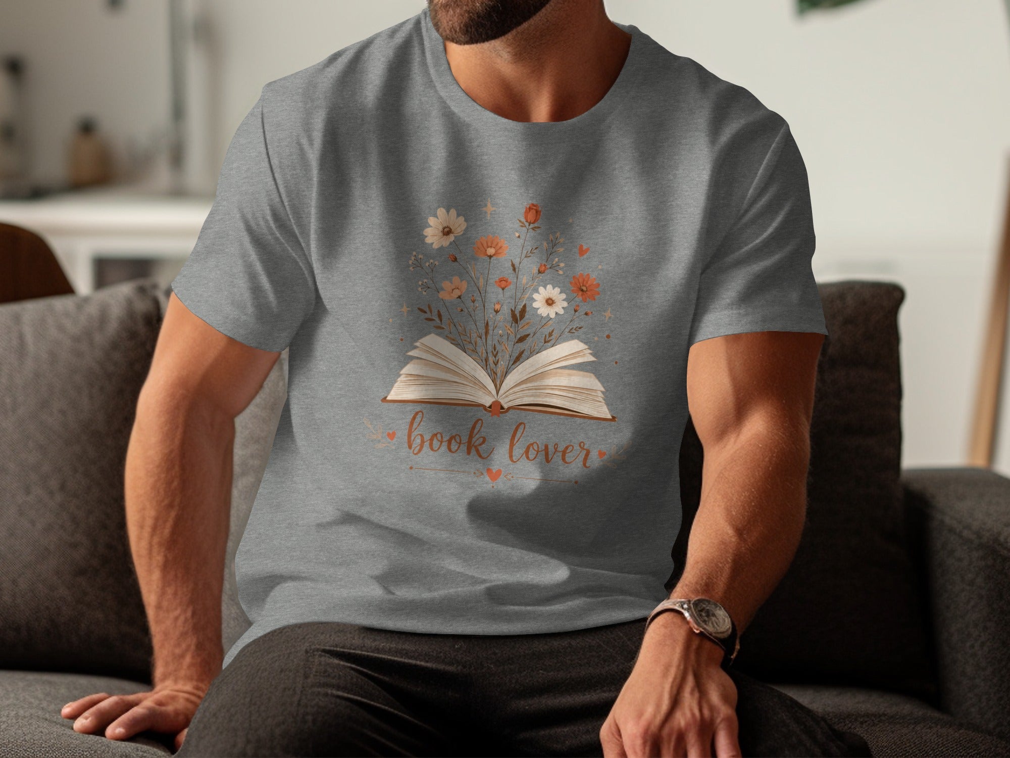 Grey t-shirt with an open book and flowers graphic, text \"book lover\".