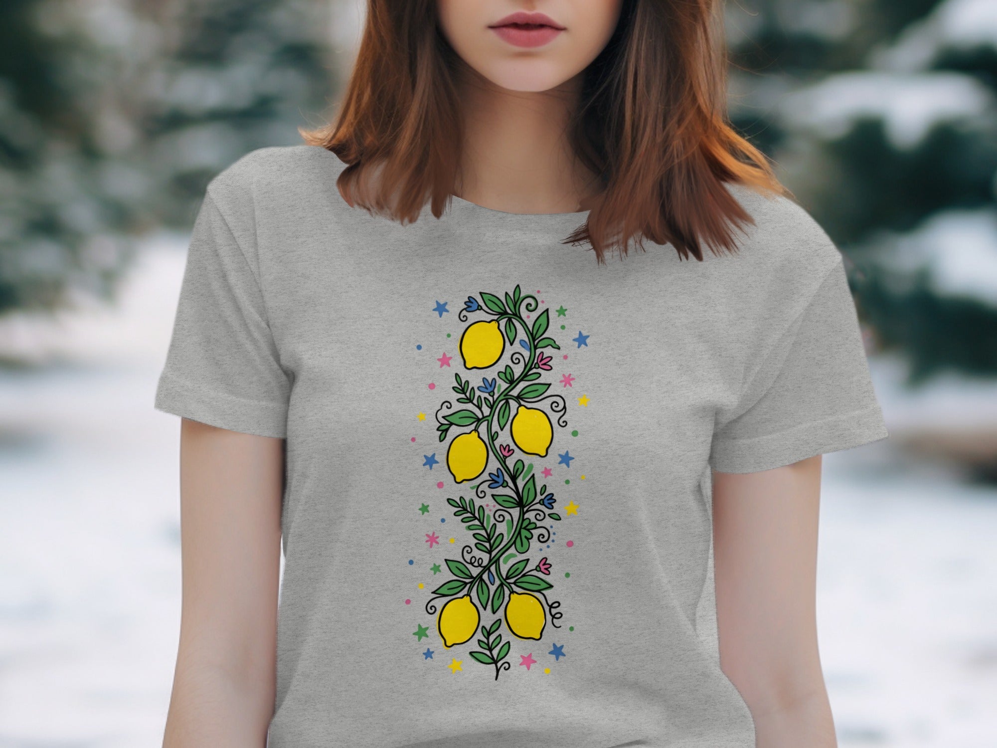 Grey t-shirt with a vertical lemon branch design and colorful stars.