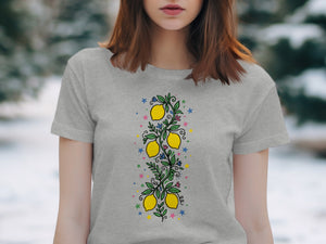 Grey t-shirt with a vertical lemon branch design and colorful stars.