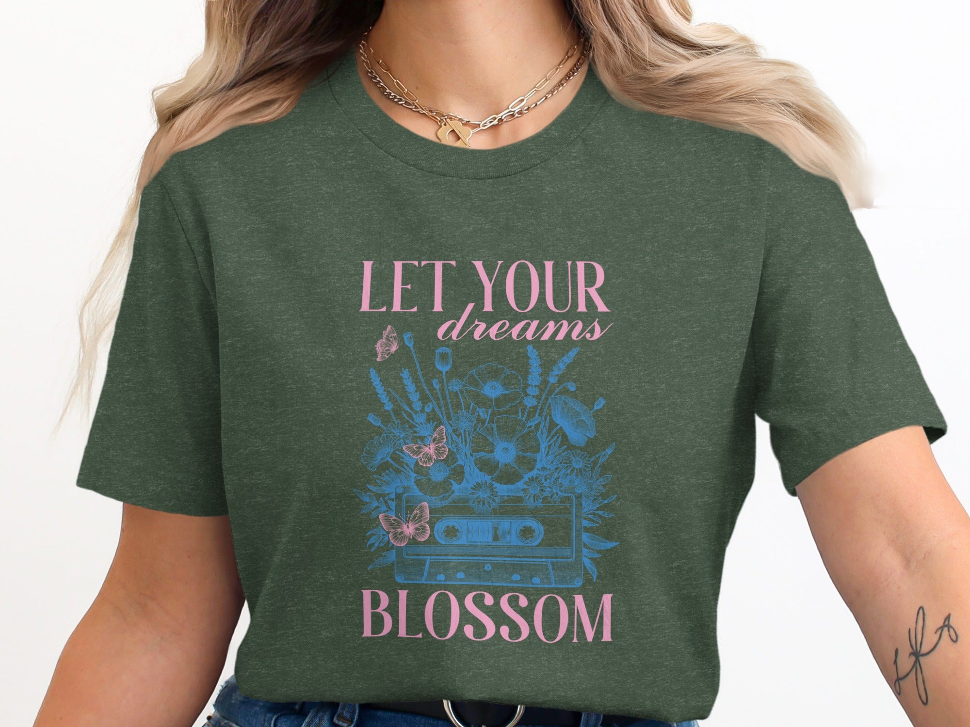 Green t-shirt with "LET YOUR dreams BLOSSOM" and cassette tape floral graphic.