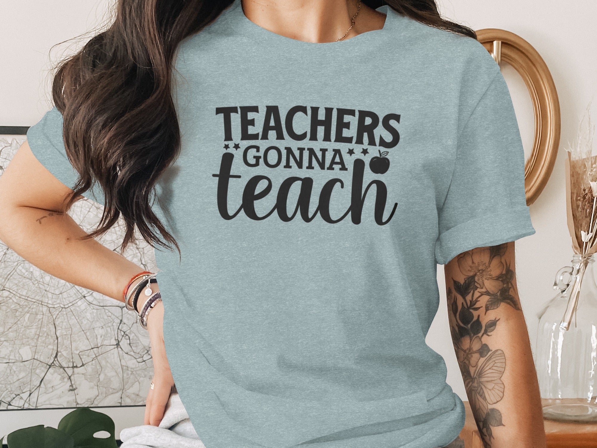 Light blue t-shirt with black text "Teachers Gonna Teach" and an apple graphic.