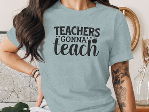 Light blue t-shirt with black text "Teachers Gonna Teach" and an apple graphic.