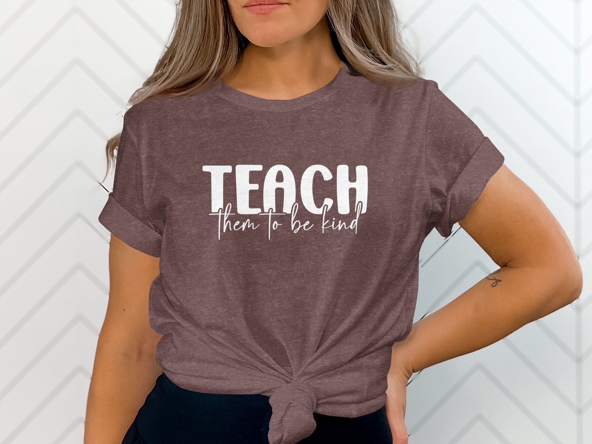 Brown t-shirt with white text "TEACH them to be kind"