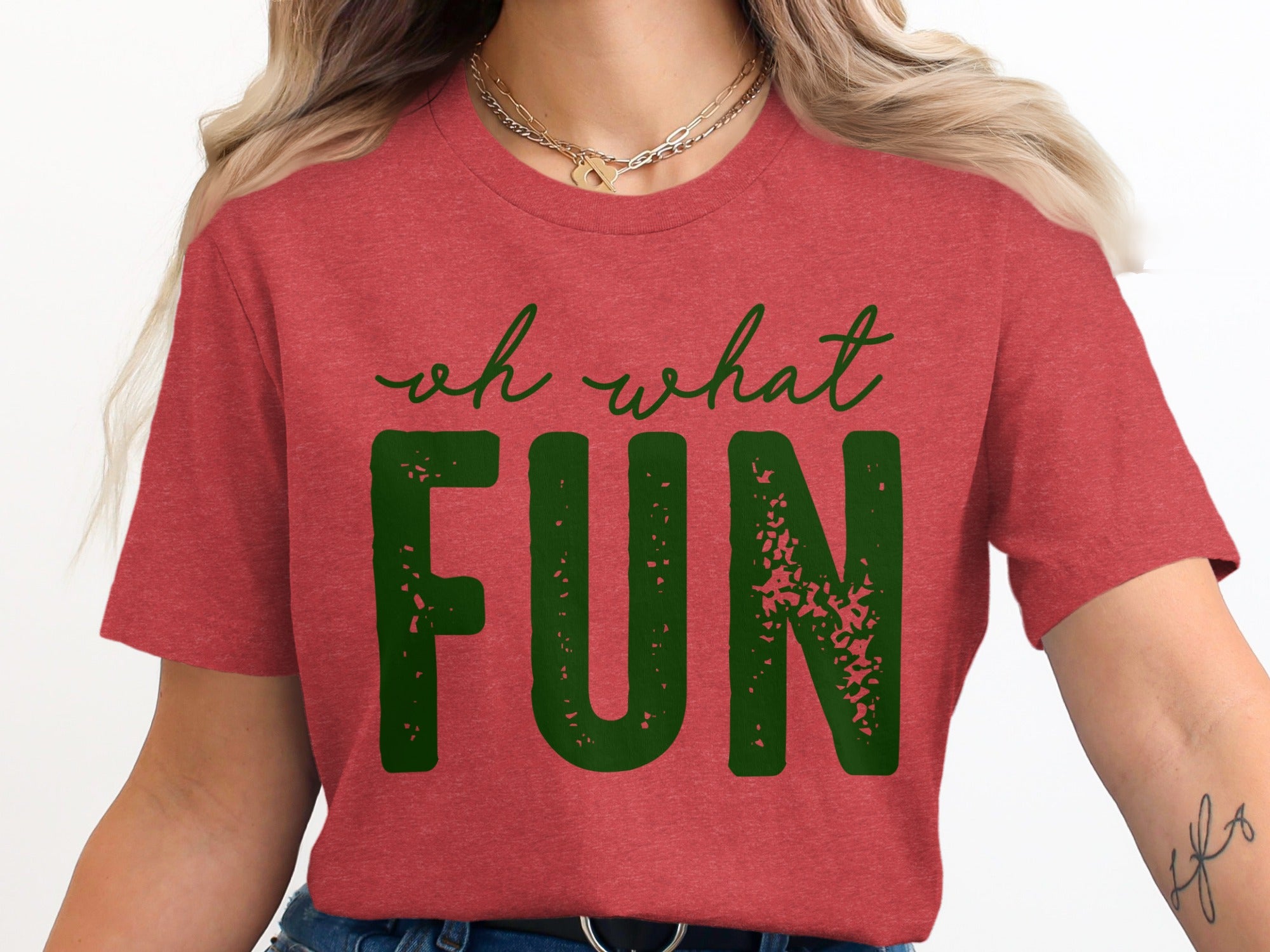 Red t-shirt with green text that says "oh what FUN".