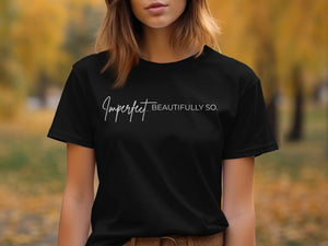 Black t-shirt with "Imperfect. BEAUTIFULLY SO." text in white script.