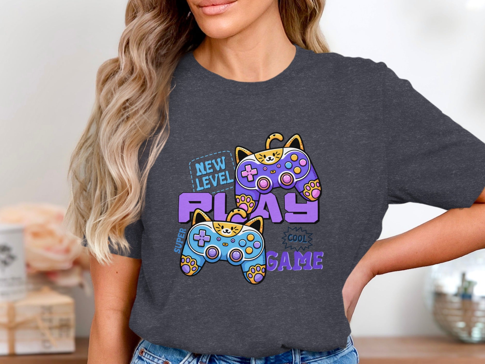 Dark grey t-shirt with cartoon cats as video game controllers and text "NEW LEVEL PLAY COOL GAME".