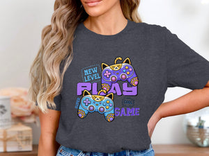 Dark grey t-shirt with cartoon cats as video game controllers and text "NEW LEVEL PLAY COOL GAME".