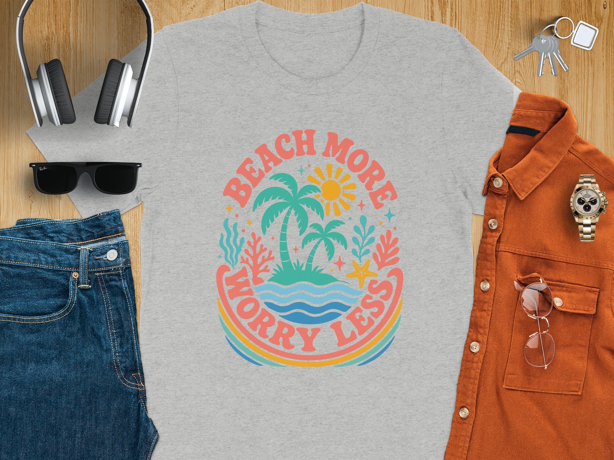 Gray t-shirt with "Beach More Worry Less" palm tree graphic and surrounding beach elements.