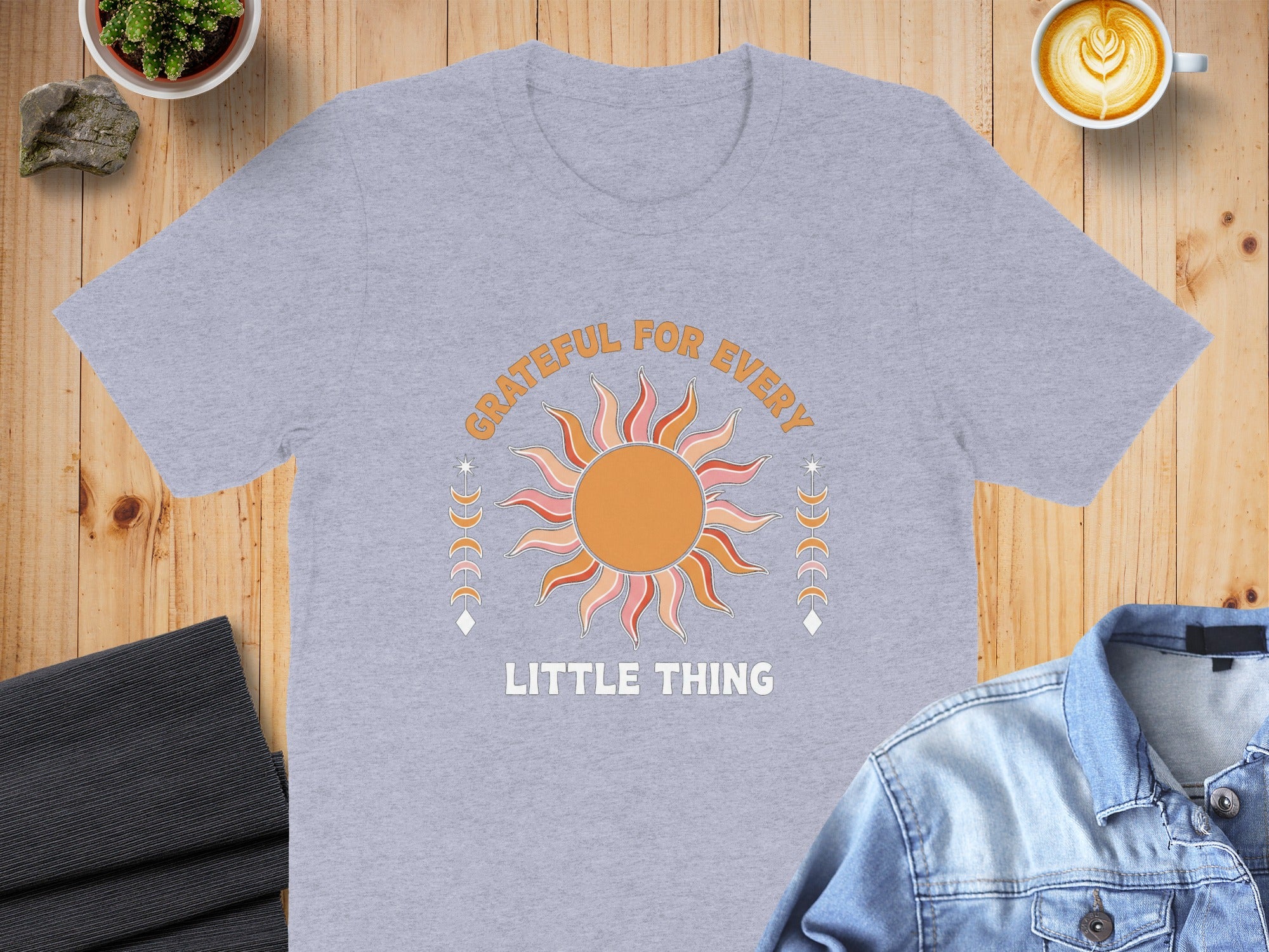 Light grey t-shirt with sun graphic and text "GRATEFUL FOR EVERY LITTLE THING."