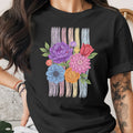 Black t-shirt with colorful floral embroidery and pastel stripes.