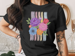 Black t-shirt with colorful floral embroidery and pastel stripes.