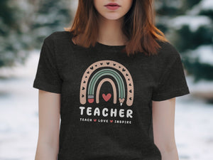 Dark t-shirt with "TEACHER TEACH LOVE INSPIRE" text and rainbow design.