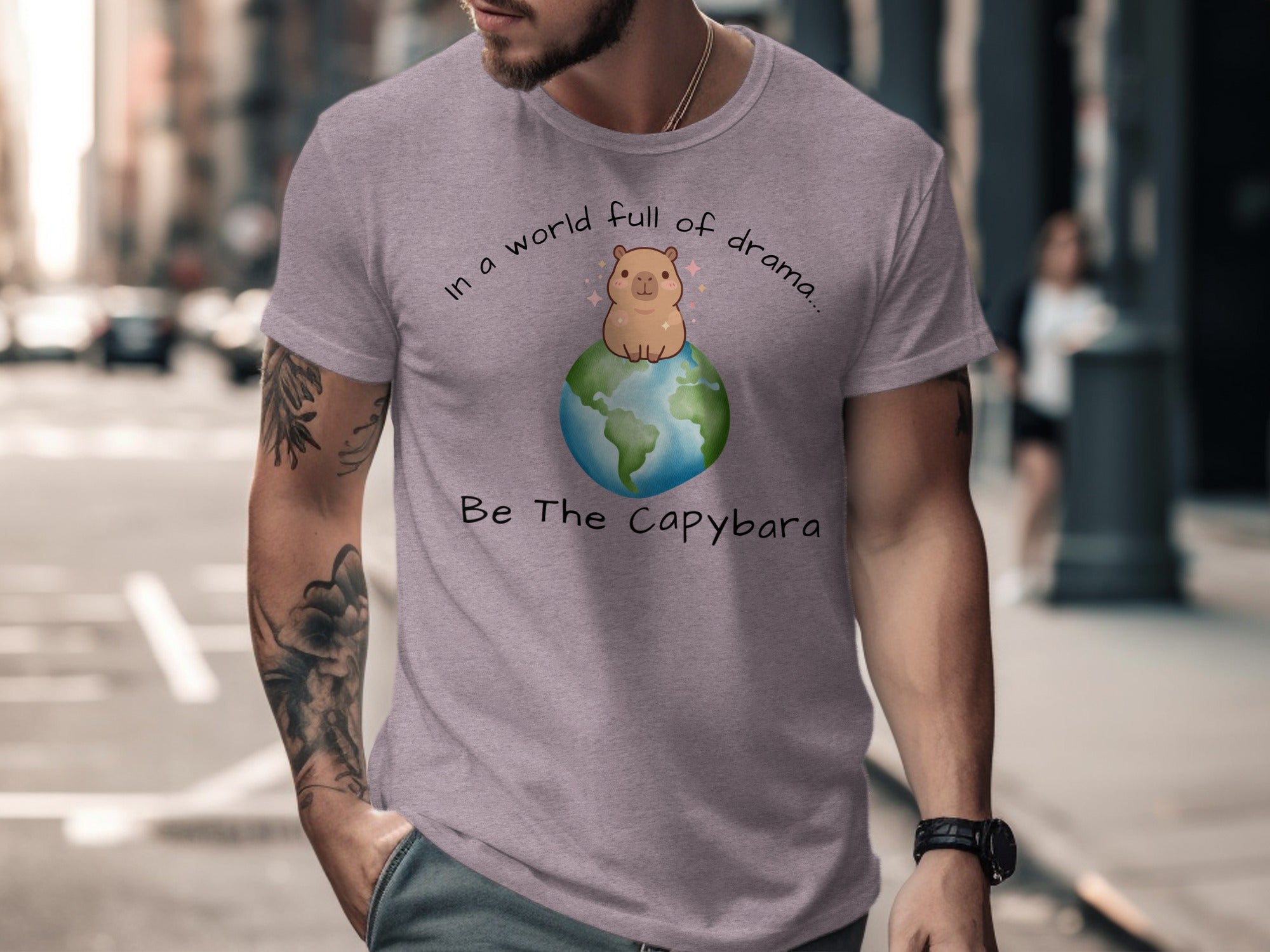 T-shirt with a capybara on Earth graphic and text "In a world full of drama... Be The Capybara".