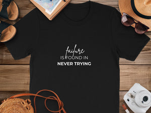 Black t-shirt with white text: "failure IS FOUND IN NEVER TRYING".