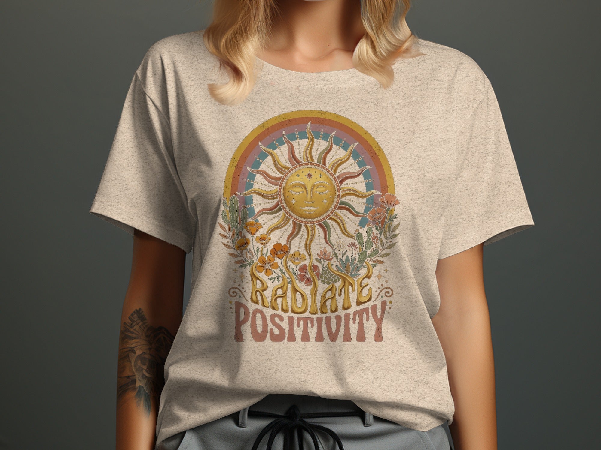 Light grey t-shirt with "Radiate Positivity" text and sun graphic.