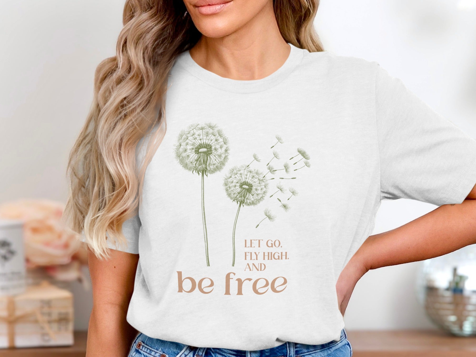 White t-shirt with dandelions and text "LET GO, FLY HIGH, AND be FREE."