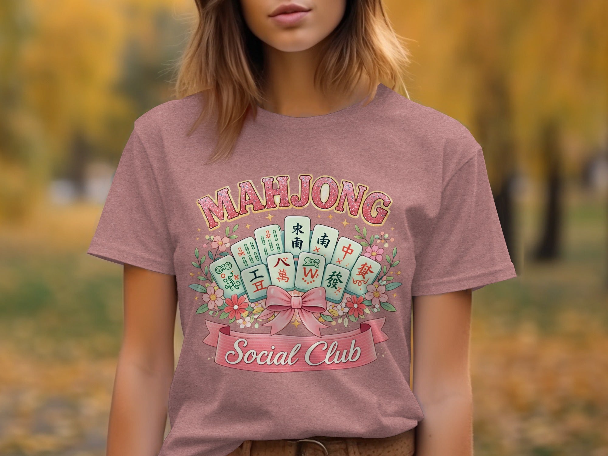 Mahjong Social Club graphic on a pink t-shirt with mahjong tiles and flowers.