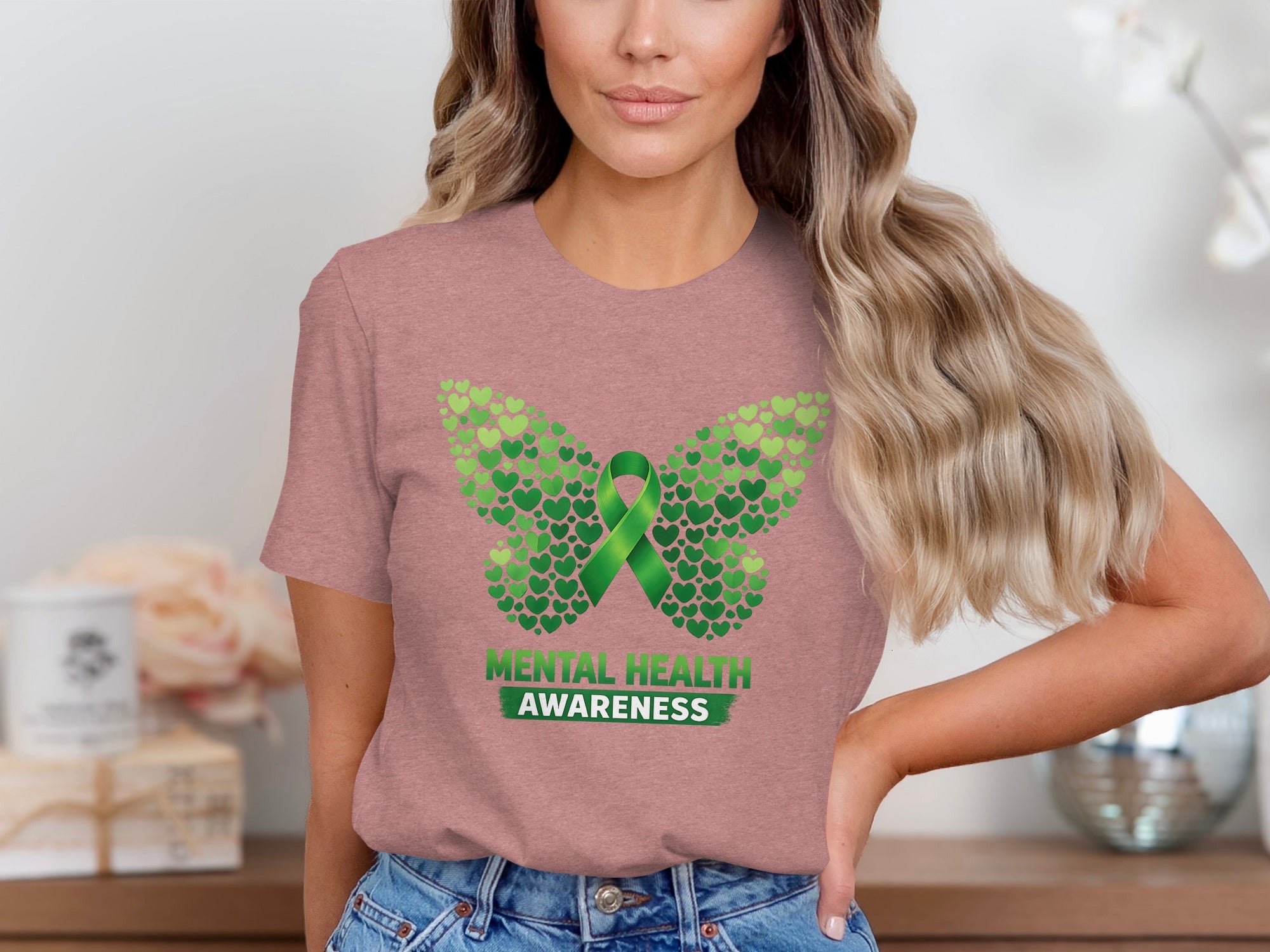 T-shirt with butterfly design made of green hearts and "Mental Health Awareness" text.