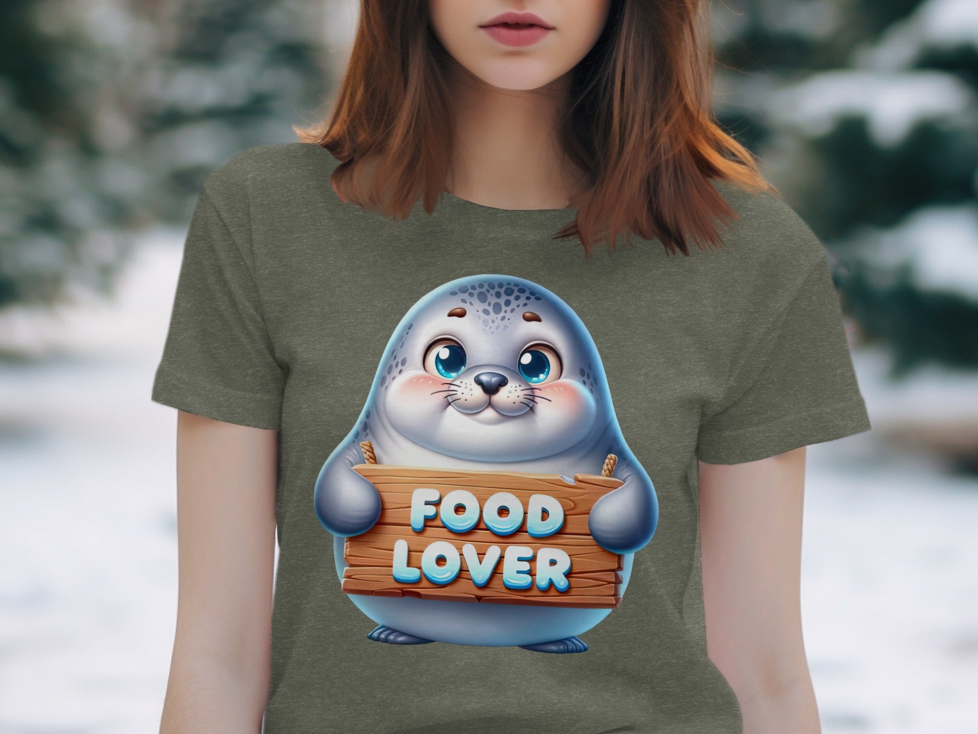 Cute seal graphic on a t-shirt holding a wooden sign that reads "FOOD LOVER."