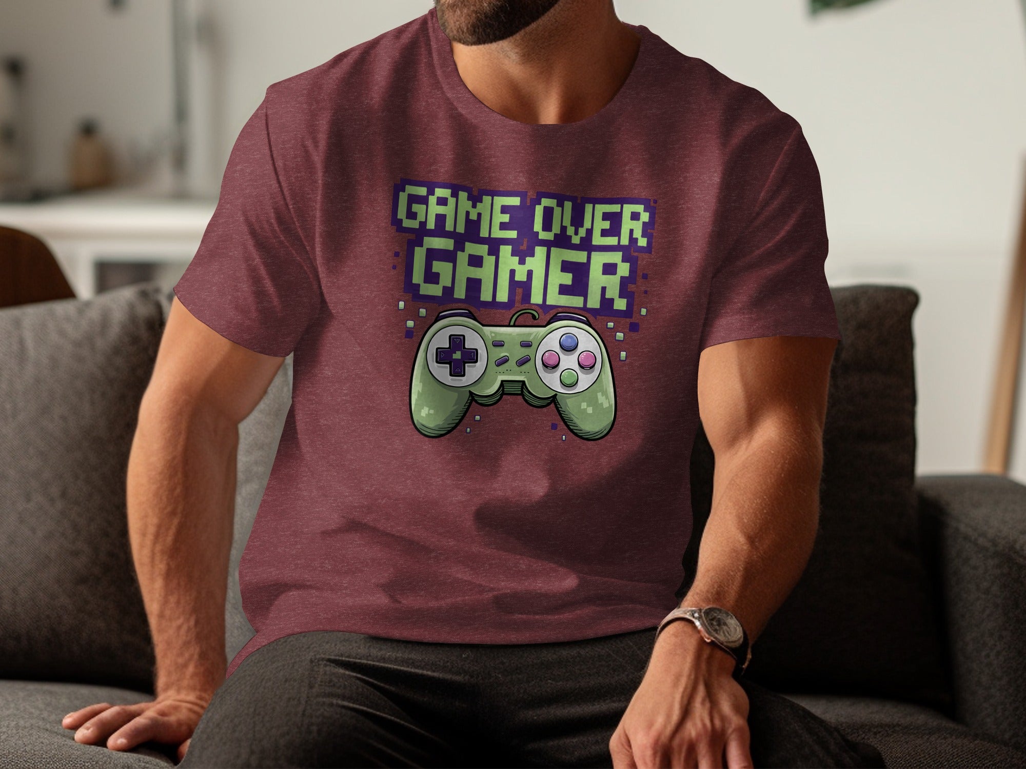 Maroon t-shirt with green pixelated "GAME OVER GAMER" text and a green gamepad.