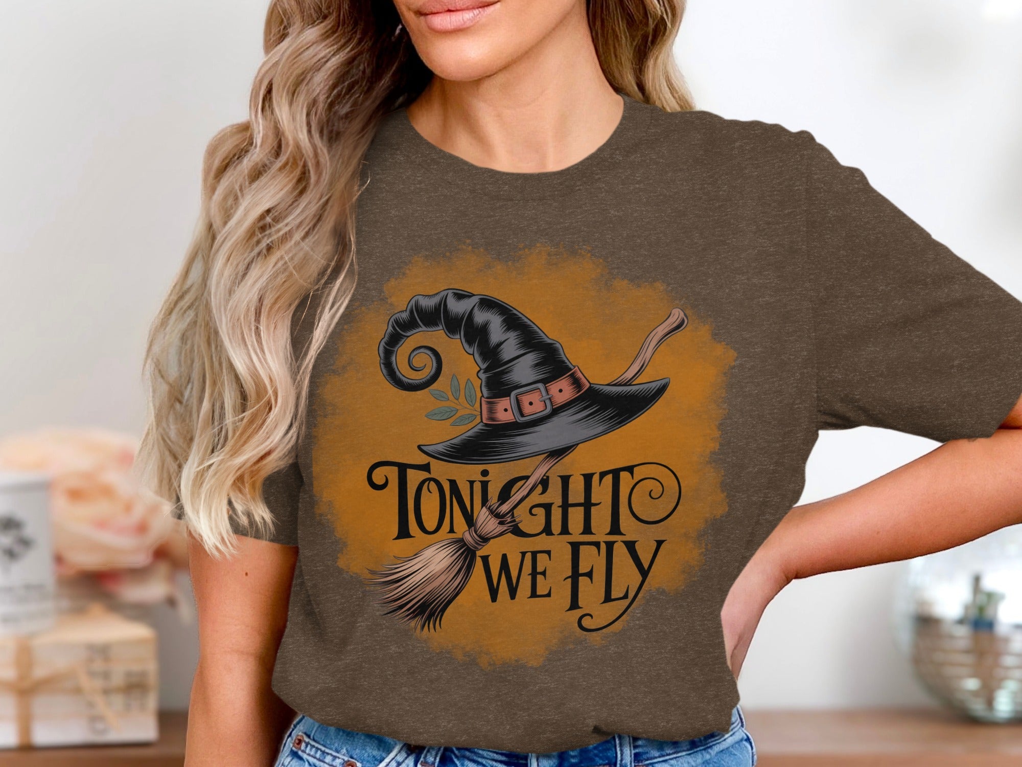 Brown t-shirt with witch's hat and broom design that says "Tonight We Fly".