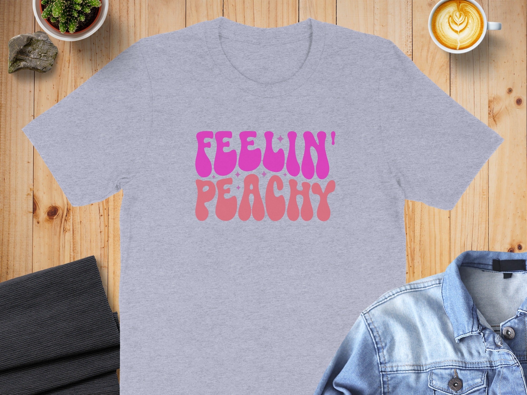 Grey t-shirt with "Feelin' Peachy" text in pink and orange.