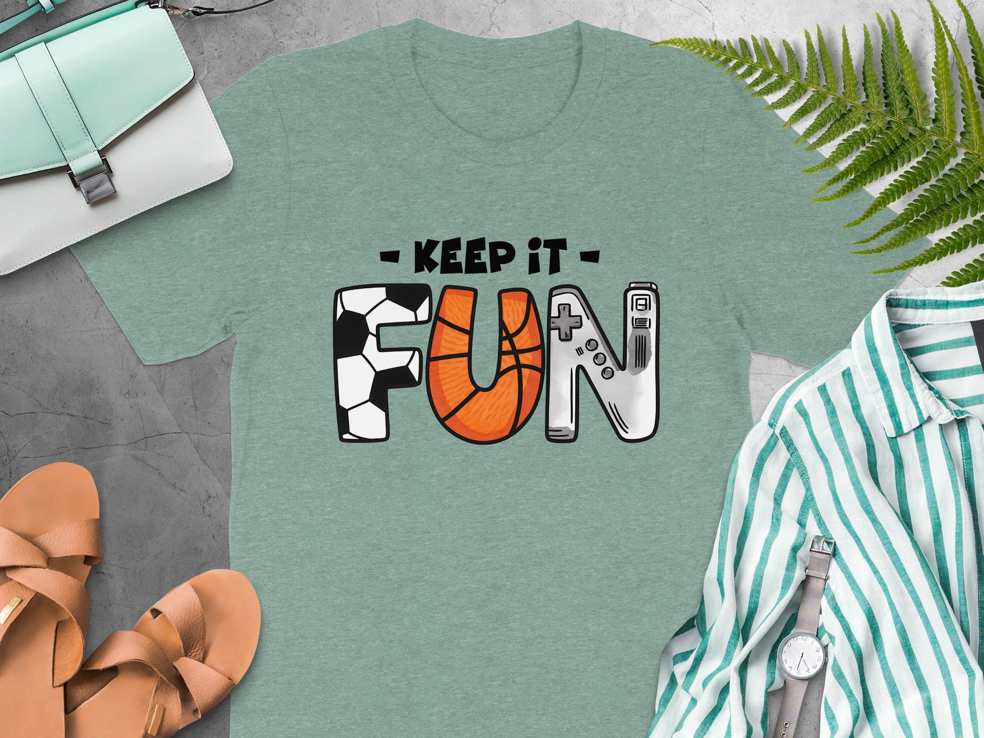 Green t-shirt with "Keep It Fun" text and icons of sports and gaming.
