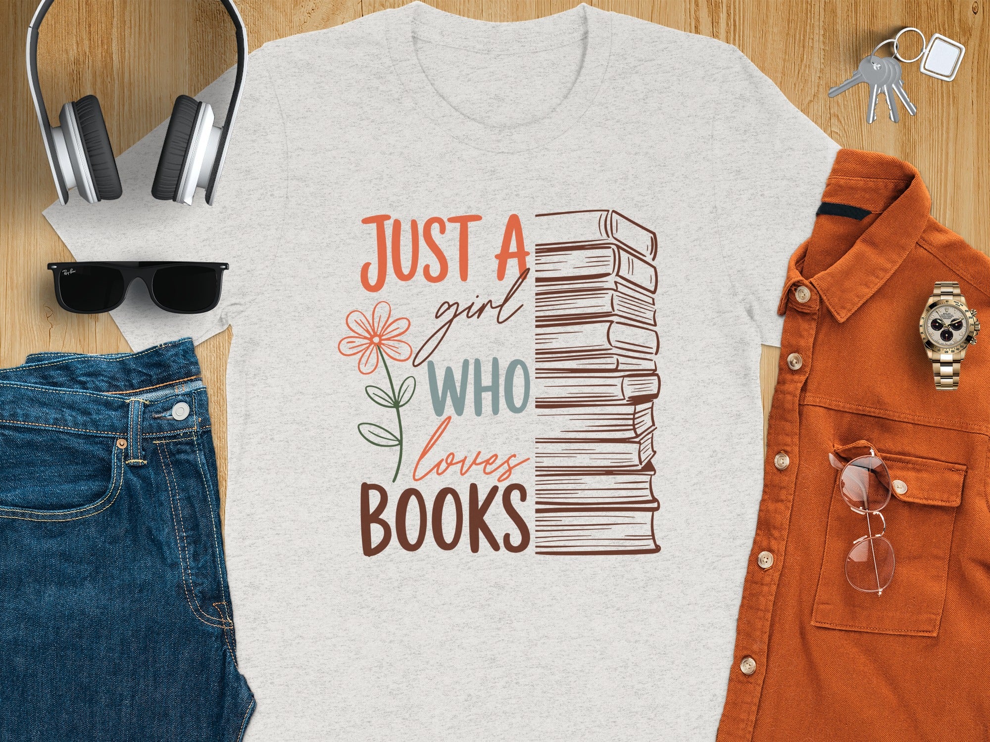 Light grey t-shirt with text "Just a girl who loves books" and stack of books graphic.