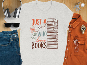 Light grey t-shirt with text "Just a girl who loves books" and stack of books graphic.