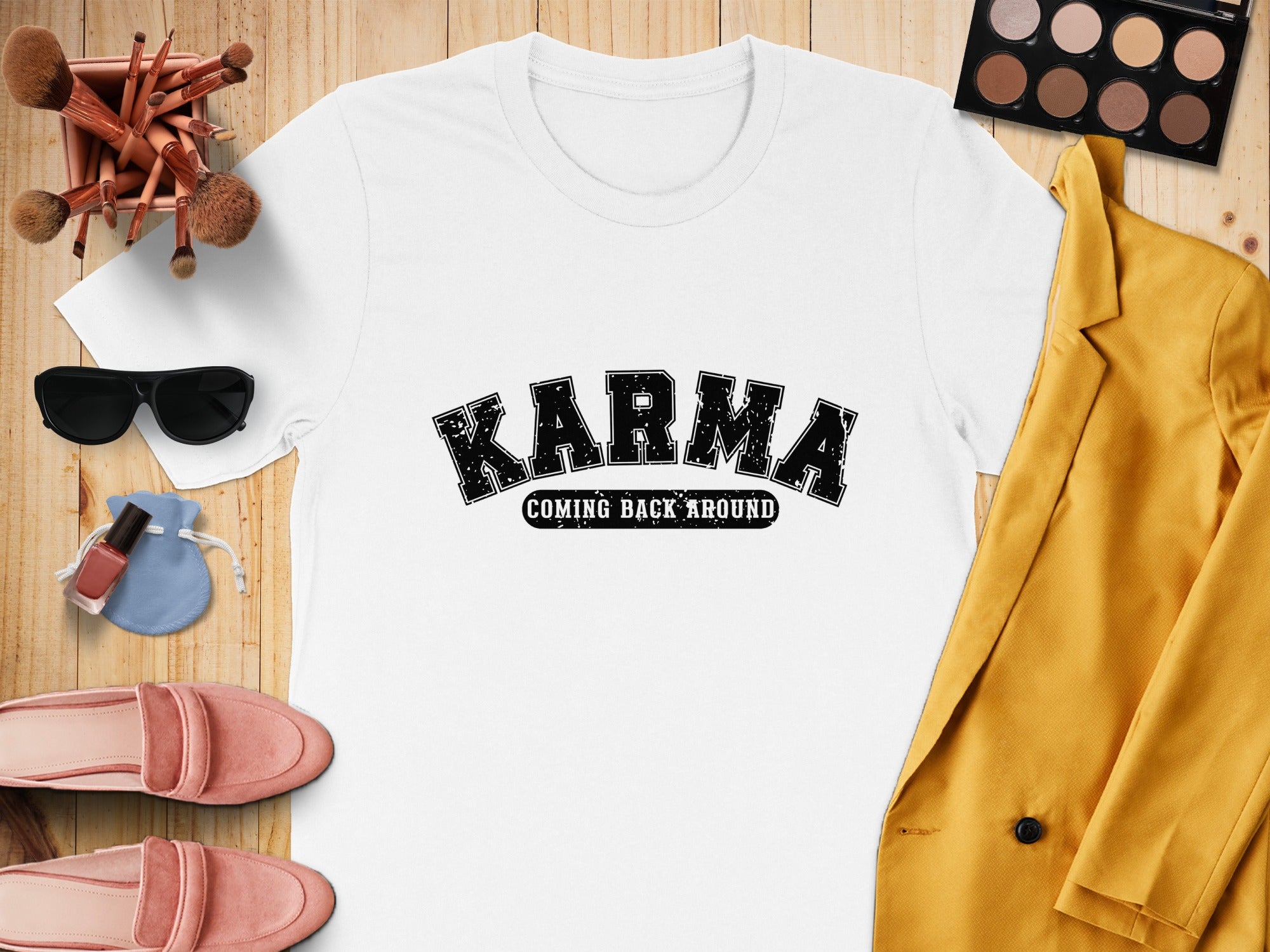White t-shirt with black "Karma Coming Back Around" text and surrounding accessories.