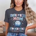 A woman wearing a dark gray t-shirt with Volleyball Mom Social Club printed across the front.