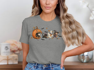 Halloween t-shirt graphic with a pumpkin, black cat, duck, and witch.
