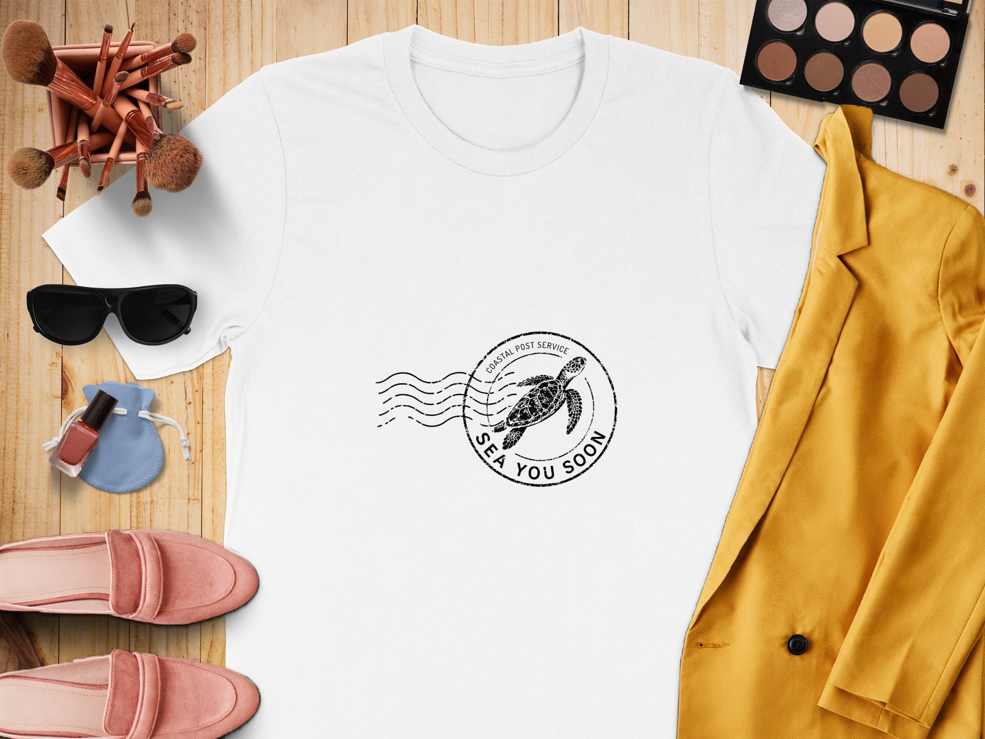 White t-shirt with a "Sea You Soon" turtle stamp graphic.