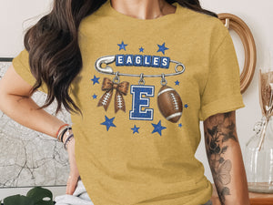 T-shirt graphic with safety pin, "EAGLES" text, football, and bow.