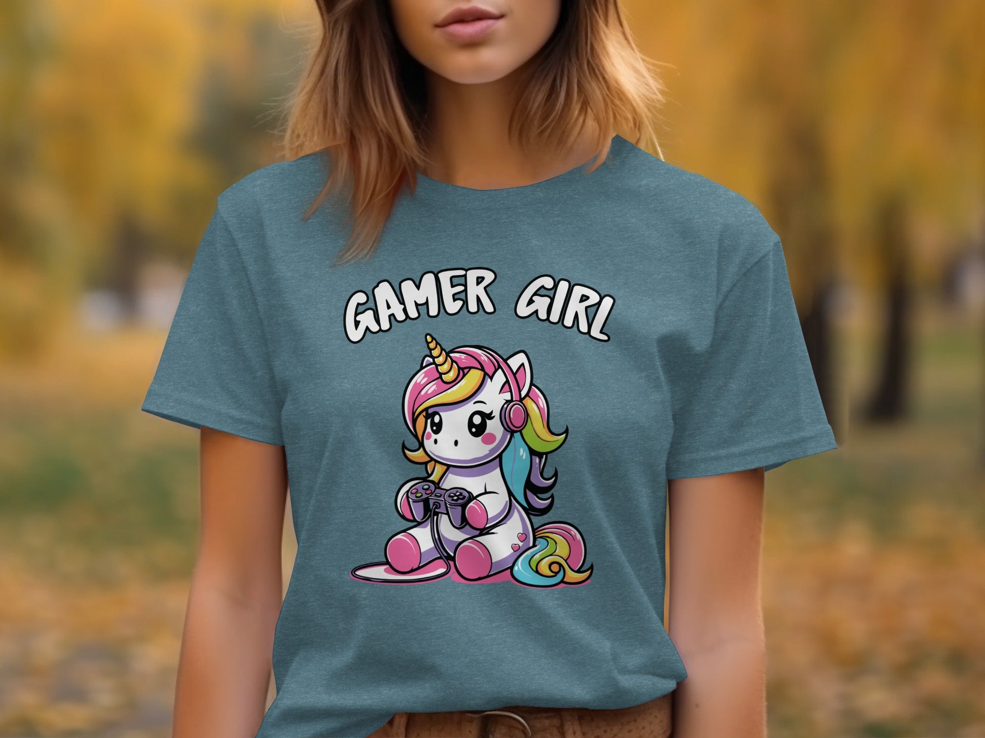 Teal t-shirt with cartoon gamer unicorn wearing headphones and holding a controller.