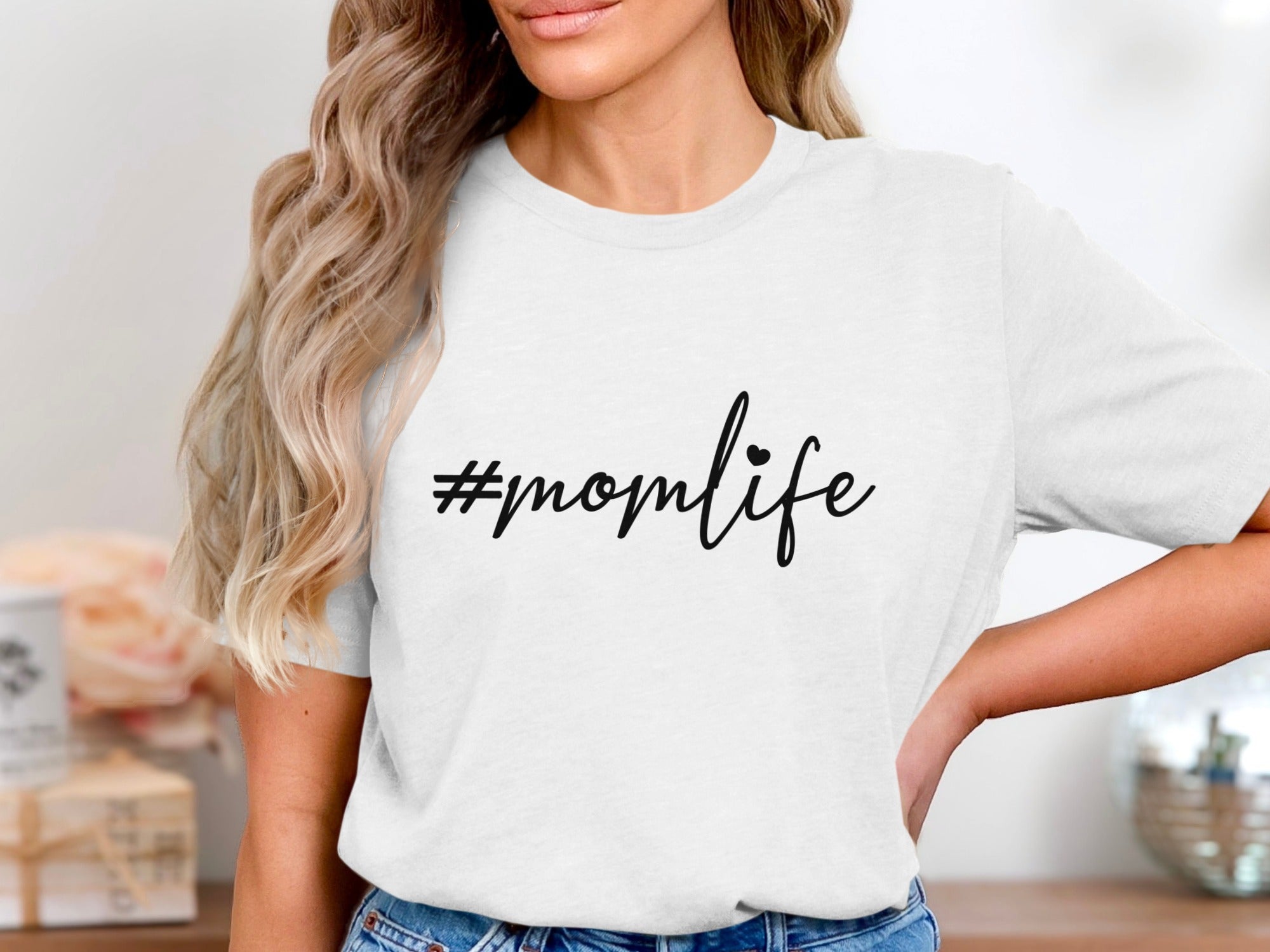 White t-shirt with black text "#momlife" and a small heart.