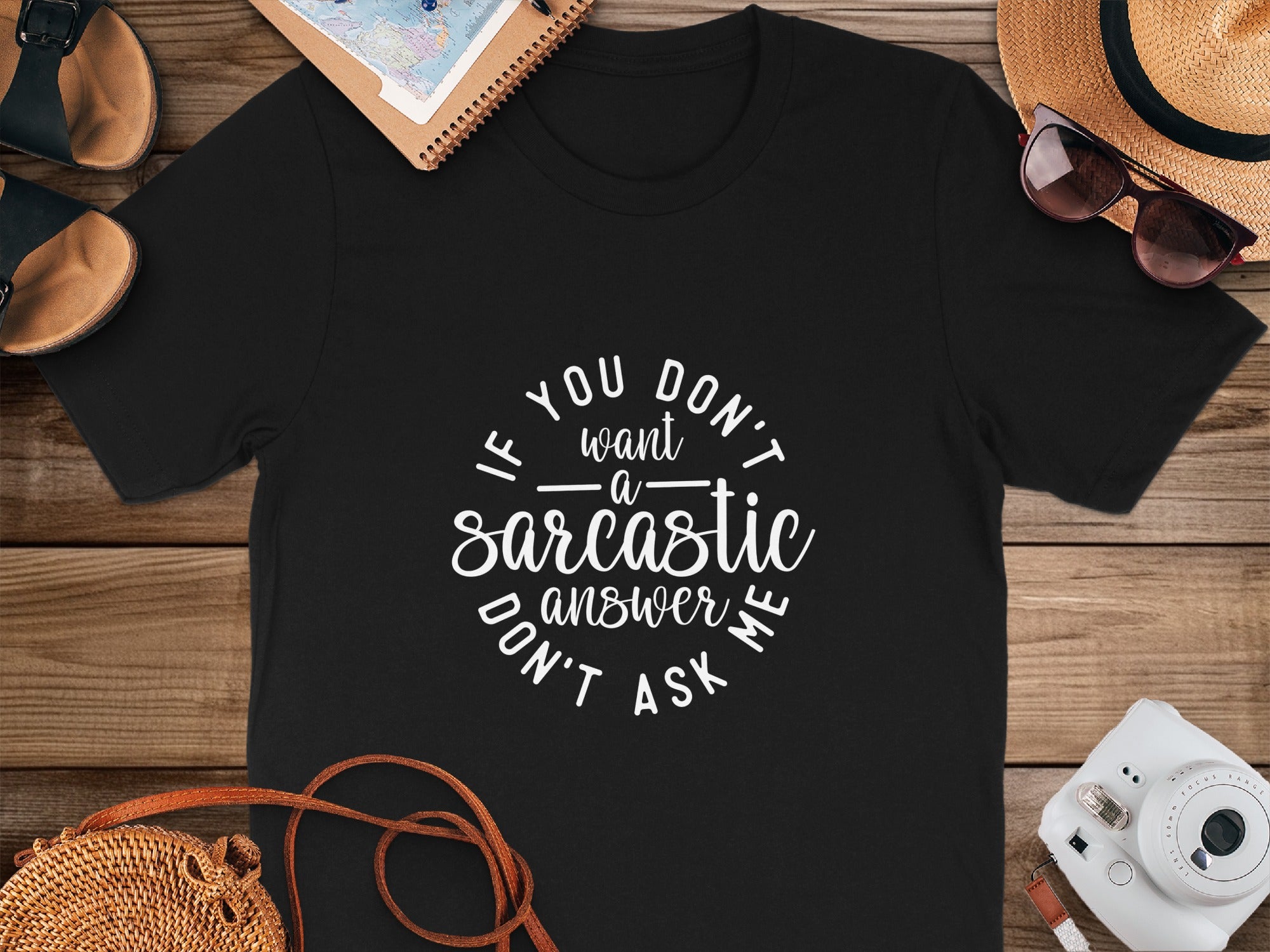 Black t-shirt with "If you don't want a sarcastic answer don't ask me" text.