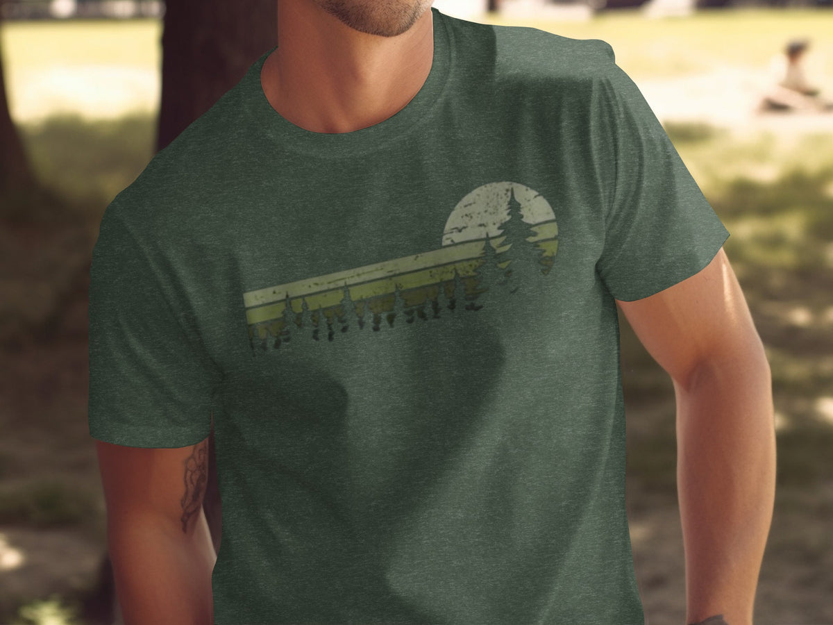 Green t-shirt with vintage forest and sun graphic print.